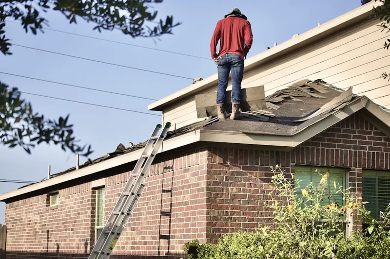 Professional roofer working on a residential roof in Rockland